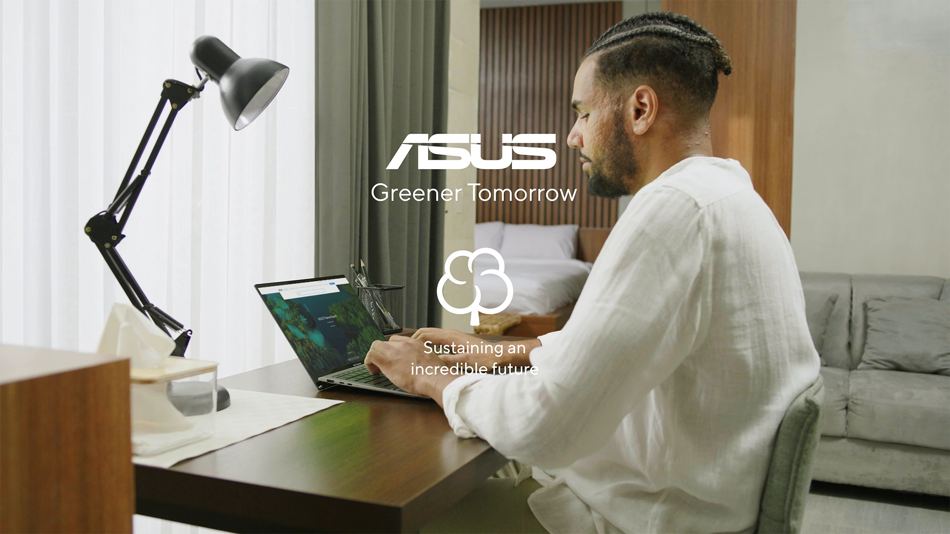 man using a laptop in his bedroom