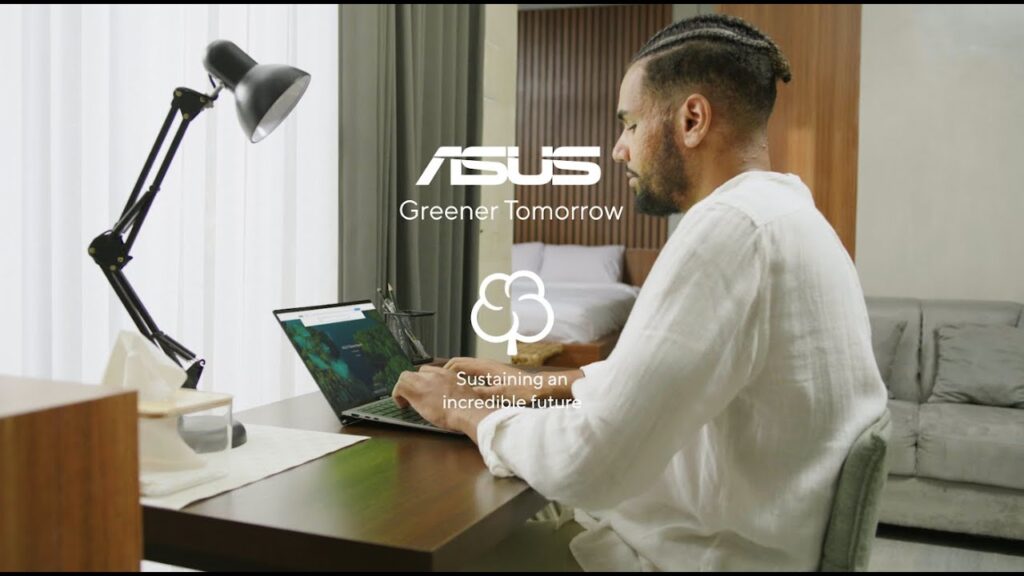 man in typing in front of a laptop during an asus esg production shoot