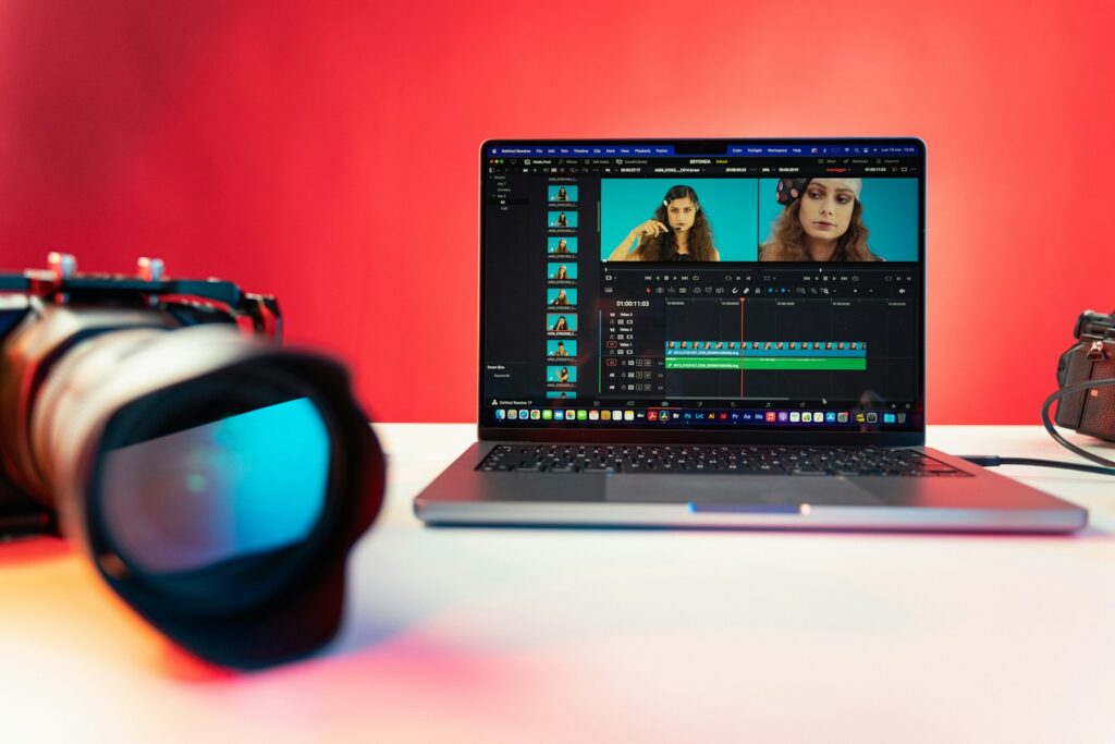 a laptop computer sitting on top of a table opening a video editing software.