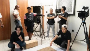 alt="SNXP Studio filming corporate video in Jakarta office with professional lighting and sound setup”