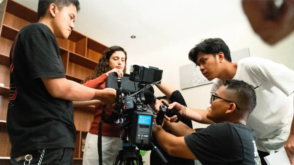 Commercial film crew setting up cinema camera