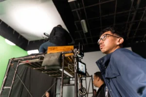 Camera and lighting setup on tripod during brand video production in Jakarta studio.