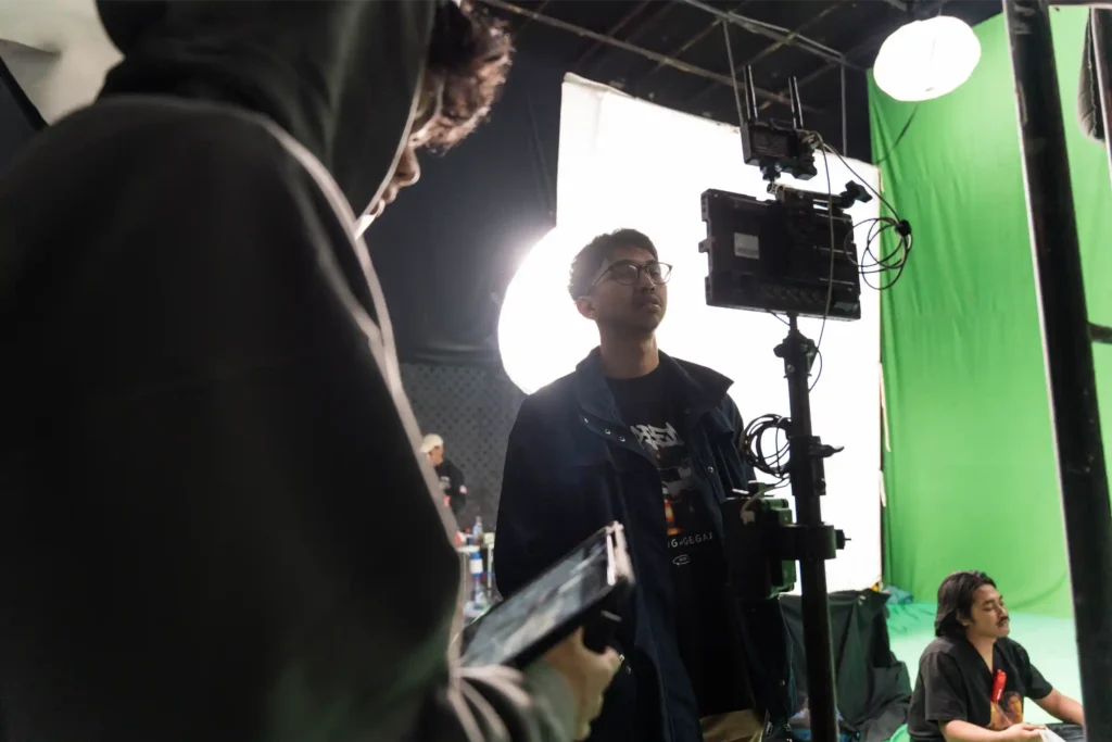 Director previewing a footage during a video production shoot.