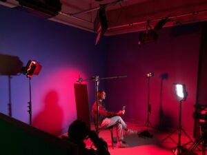 alt="Studio production crew setting up camera with lighting for corporate testimonial in Jakarta"