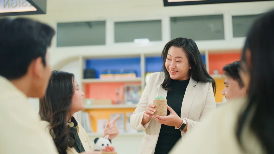 a frame of school teacher explaining to student in a company profile